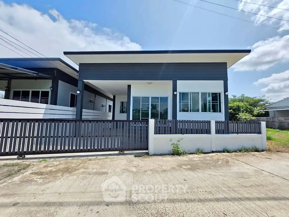 Modern single-story house with sleek design and spacious front yard