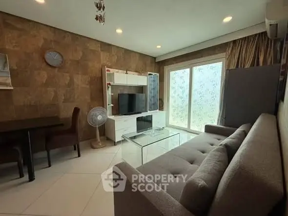Modern living room with stylish decor, large sofa, and entertainment center, perfect for relaxation and entertainment.