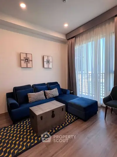 Stylish living room with blue sofa and modern decor in a bright apartment.