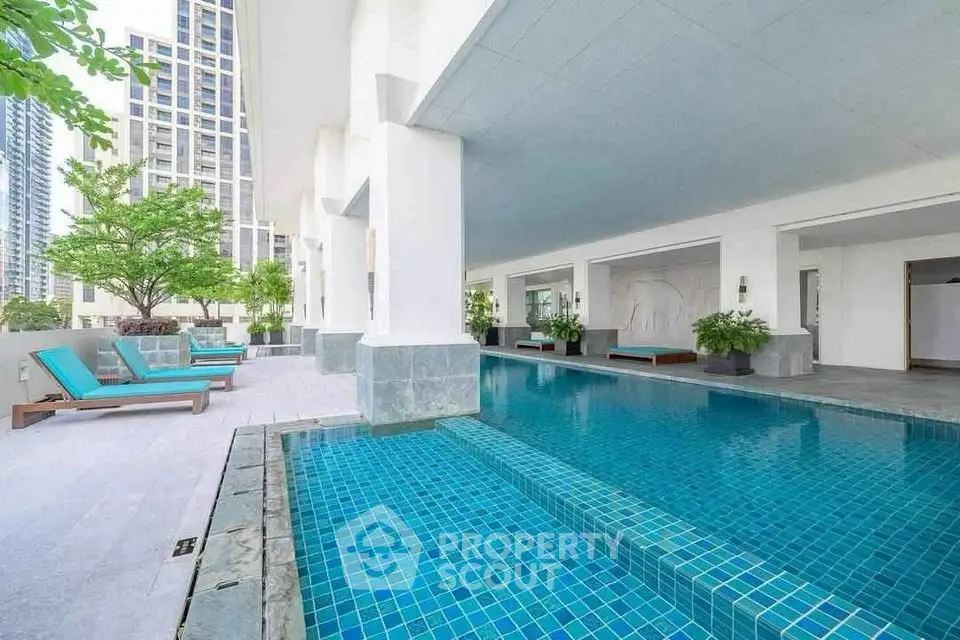 Luxurious condominium with modern pool and lounging area in urban setting
