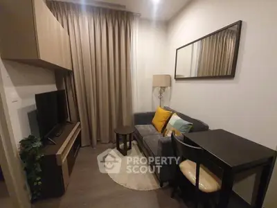 Cozy living room with modern decor, featuring a comfortable sofa, TV, and dining area.