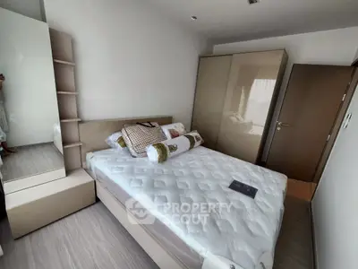 Modern bedroom with sleek design and ample storage in a contemporary apartment.