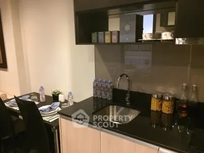 Modern kitchen with sleek cabinetry and dining area, perfect for urban living.