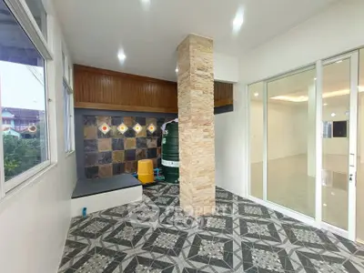 Spacious modern interior with unique tile flooring and stone accent wall, perfect for stylish living.