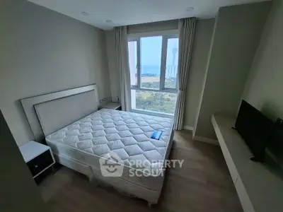 Modern bedroom with large window offering stunning cityscape view