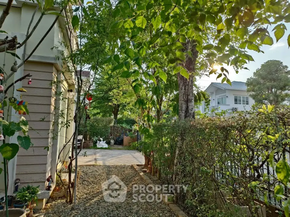 Charming garden pathway with lush greenery and cozy home exterior, perfect for nature lovers seeking tranquility.