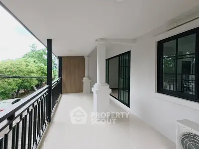 Spacious balcony with modern railing and serene view