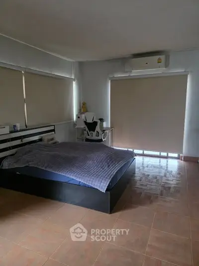 Spacious bedroom with modern furnishings and natural light