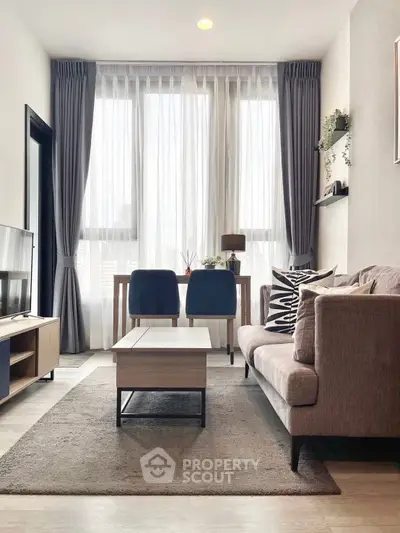 Modern living room with stylish furniture and large windows for natural light.