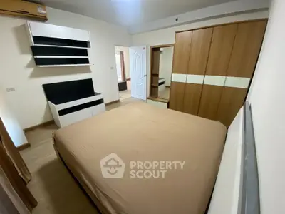 Spacious bedroom with modern furniture and ample storage space