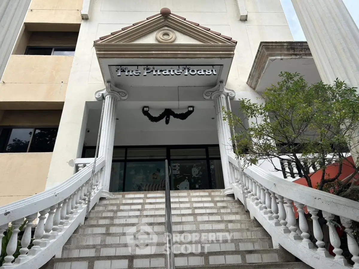 Elegant building entrance with grand staircase and decorative columns