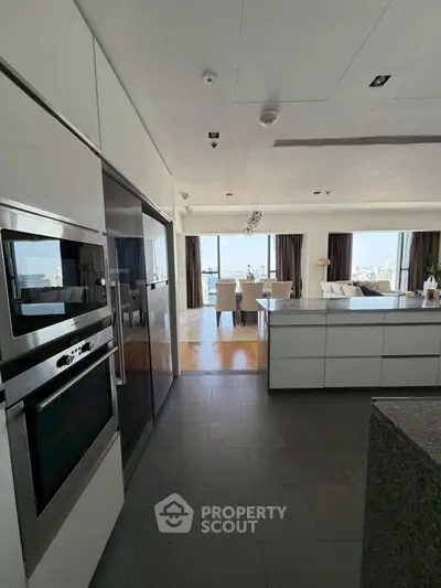 Luxurious open-plan kitchen and living area with stunning city views.