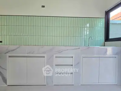 Modern kitchen with sleek cabinetry and stylish backsplash