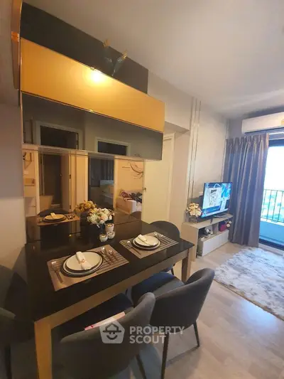 Stylish modern living room with elegant dining setup and cozy TV area.