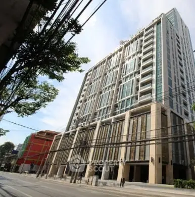 Modern high-rise building with contemporary design and large windows in urban setting.