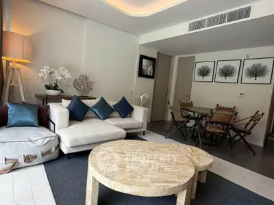 Stylish living room with modern decor and cozy dining area, perfect for urban living.
