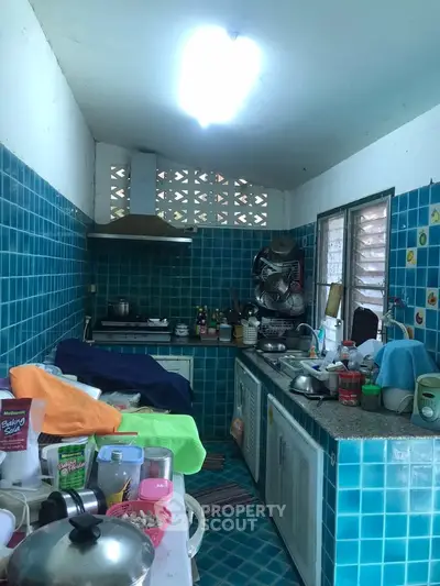 Cozy kitchen with vibrant blue tiles and ample counter space