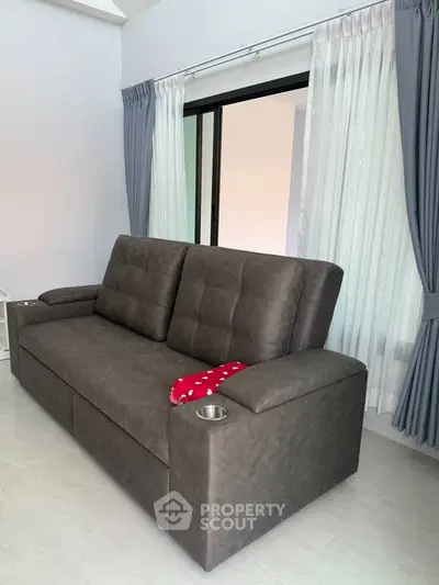 Modern living room with stylish gray sofa and elegant curtains