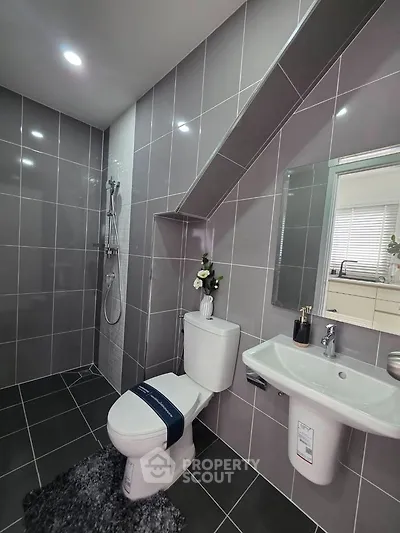Modern bathroom with sleek gray tiles and stylish fixtures