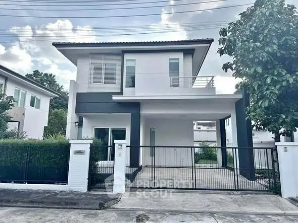 Modern two-story house with sleek design and spacious driveway in a serene neighborhood.