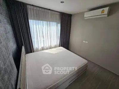 Modern bedroom with large window and air conditioning unit