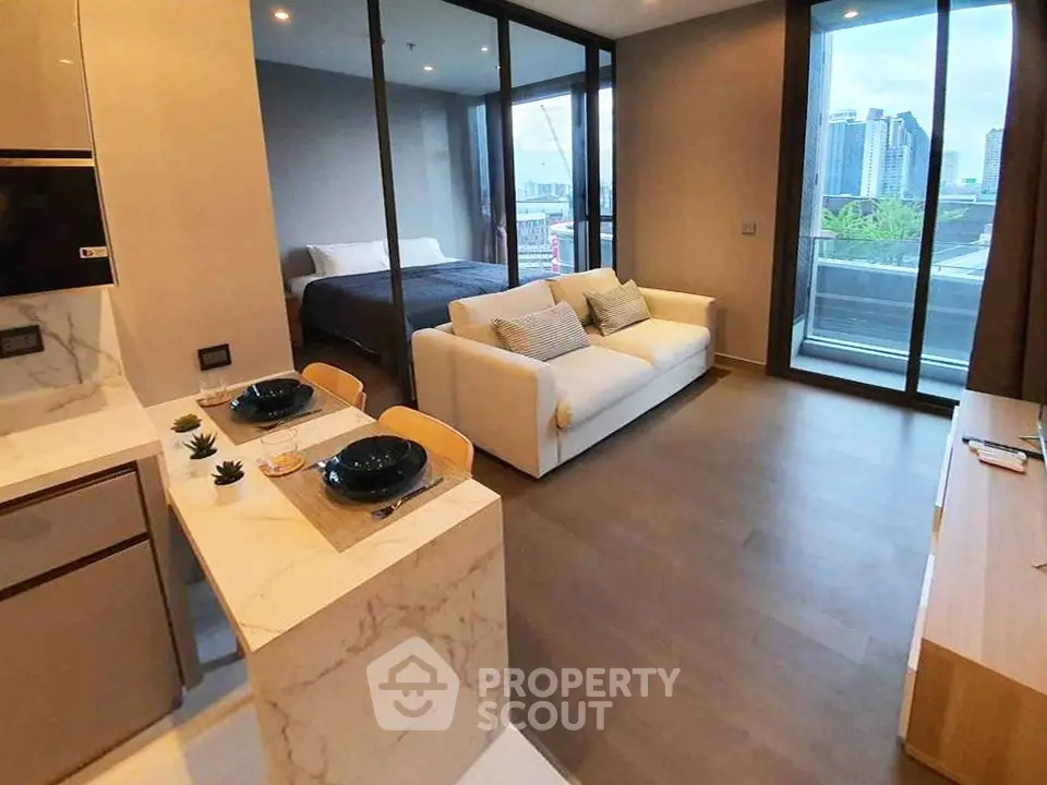 Modern open-plan studio with city view and stylish interior design