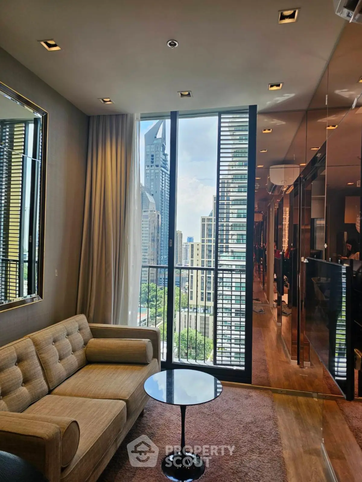 Luxurious living room with stunning city view and modern furnishings in high-rise apartment.