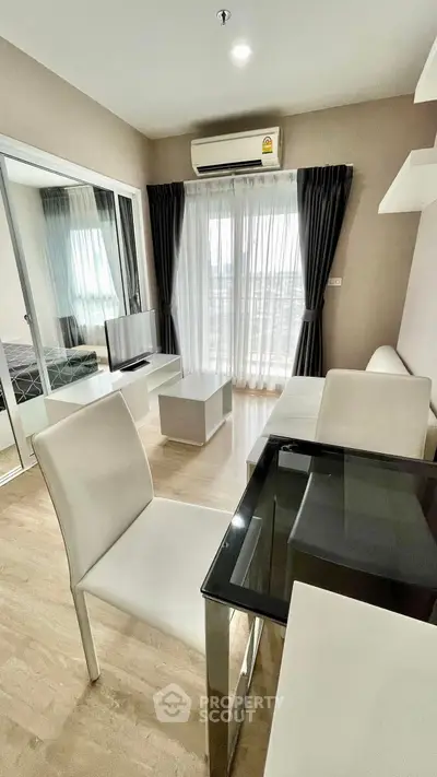 Modern living room with sleek furniture and large windows in a stylish apartment.