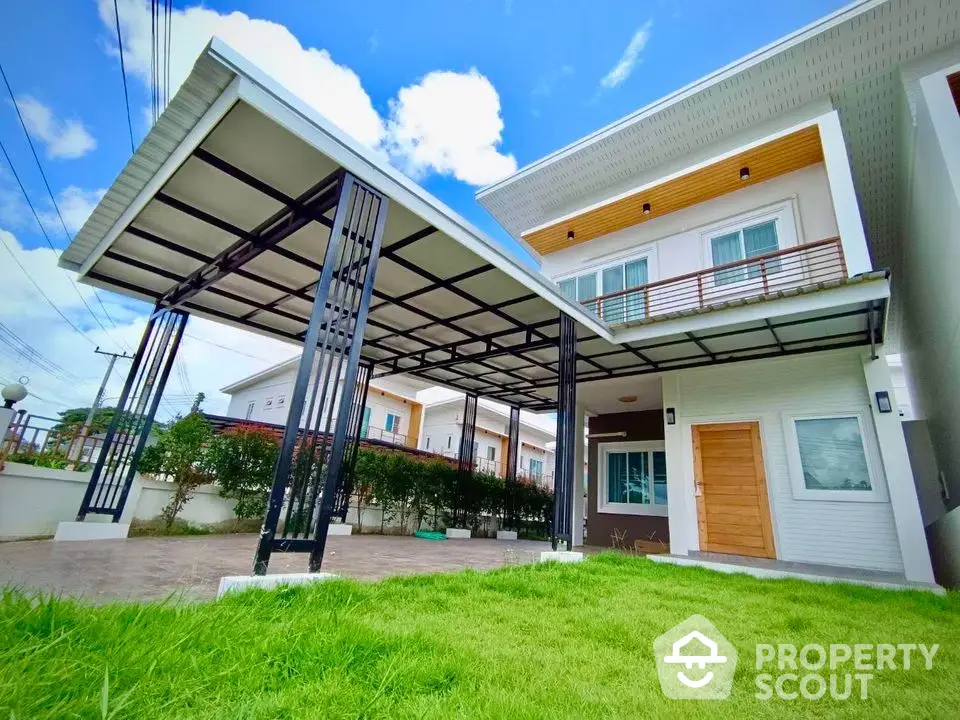 Modern two-story house with spacious carport and lush green lawn