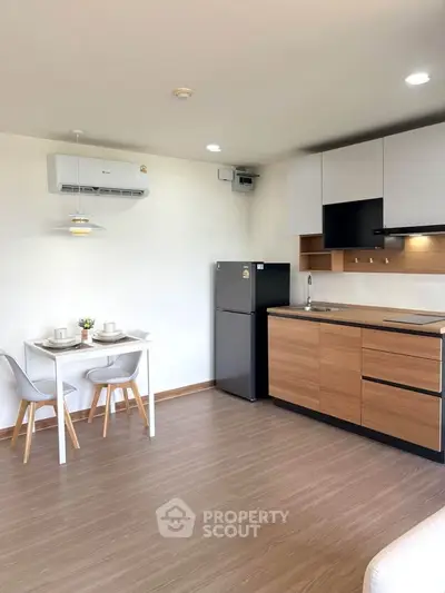 Modern kitchen with sleek design and dining area in open layout apartment