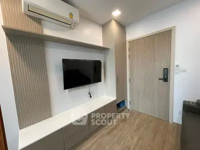 Modern living room with wall-mounted TV and air conditioning unit