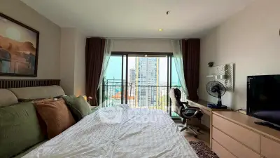 Spacious bedroom with balcony view in modern apartment