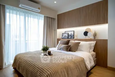 Modern bedroom with stylish decor and natural light, featuring a cozy bed and elegant wooden accents.