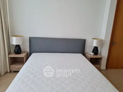 Spacious bedroom with modern decor and comfortable bed in a stylish apartment.