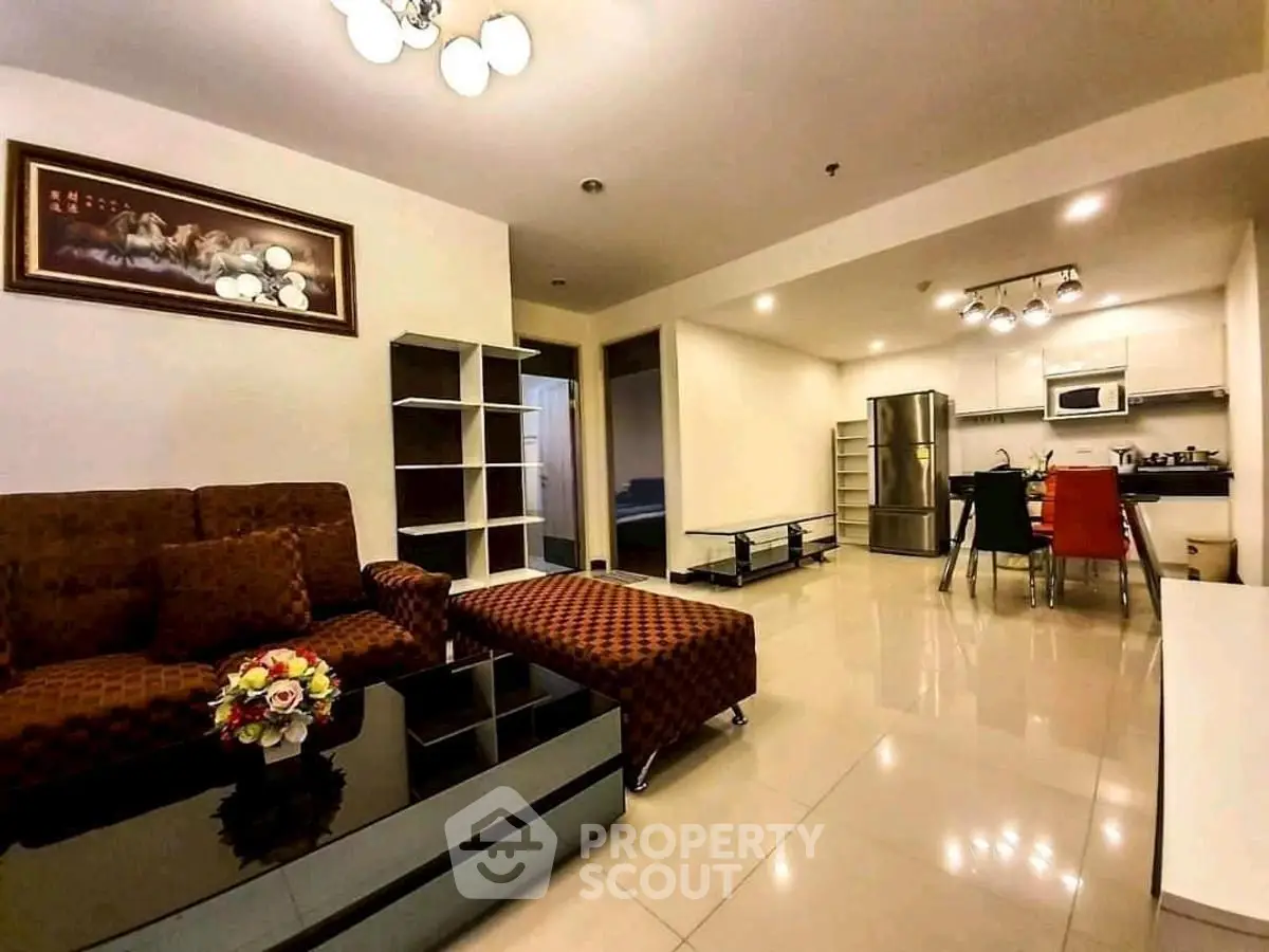 Spacious open-layout living room with modern kitchen and stylish furniture in a contemporary apartment.