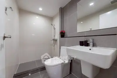 Modern bathroom with sleek fixtures and spacious shower area