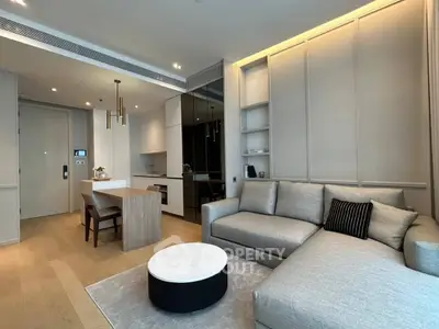 Modern living room with sleek design, featuring a cozy gray sofa, stylish coffee table, and elegant dining area.
