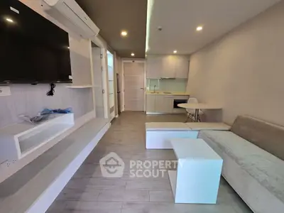 Modern living room with sleek furniture and open kitchen layout