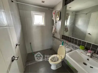 Modern bathroom with sleek tiles and natural light from window