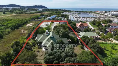 Expansive property with lush greenery and scenic views near the coast, ideal for development or private estate.