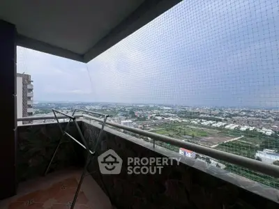 Spacious balcony with panoramic city view and safety netting