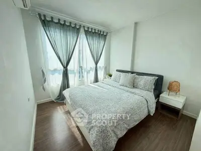 Bright and cozy bedroom with elegant decor and large windows