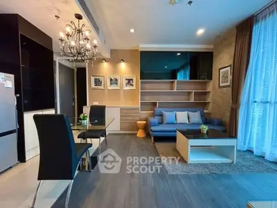 Modern living room with elegant chandelier and stylish furniture in a cozy apartment.