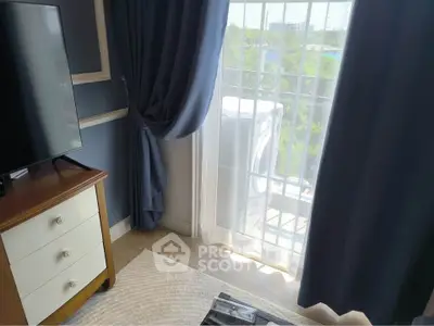 Charming bedroom with elegant decor and natural light from large window.