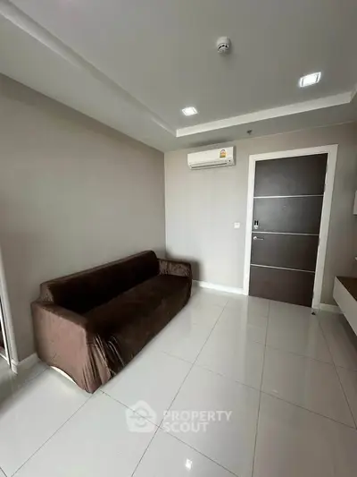Modern living room with sleek brown sofa and air conditioning in minimalist apartment.