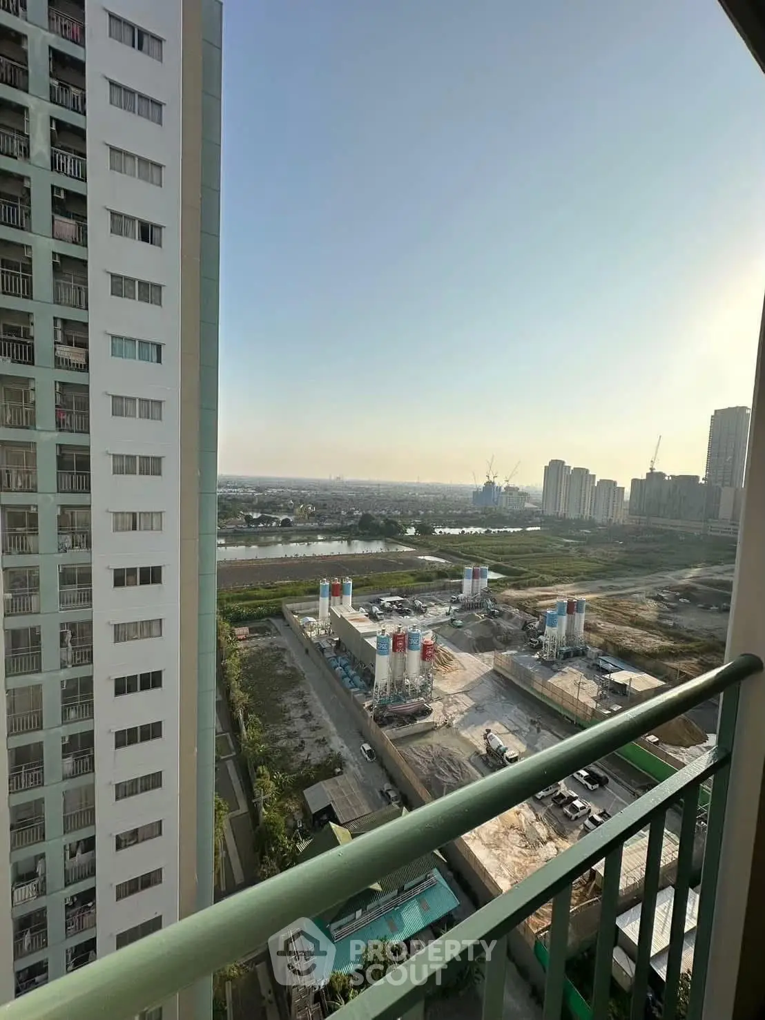 Stunning high-rise balcony view overlooking cityscape and construction site