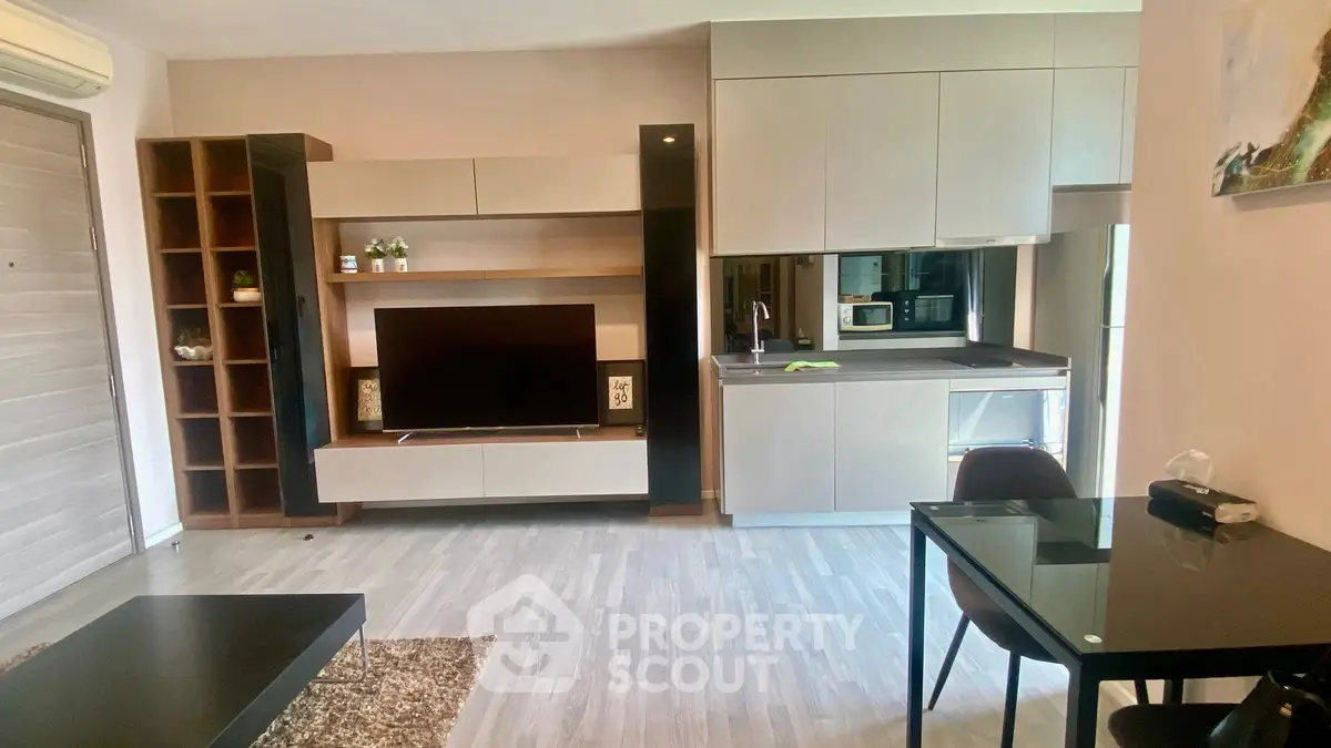 Modern living room with sleek furniture and integrated kitchen area