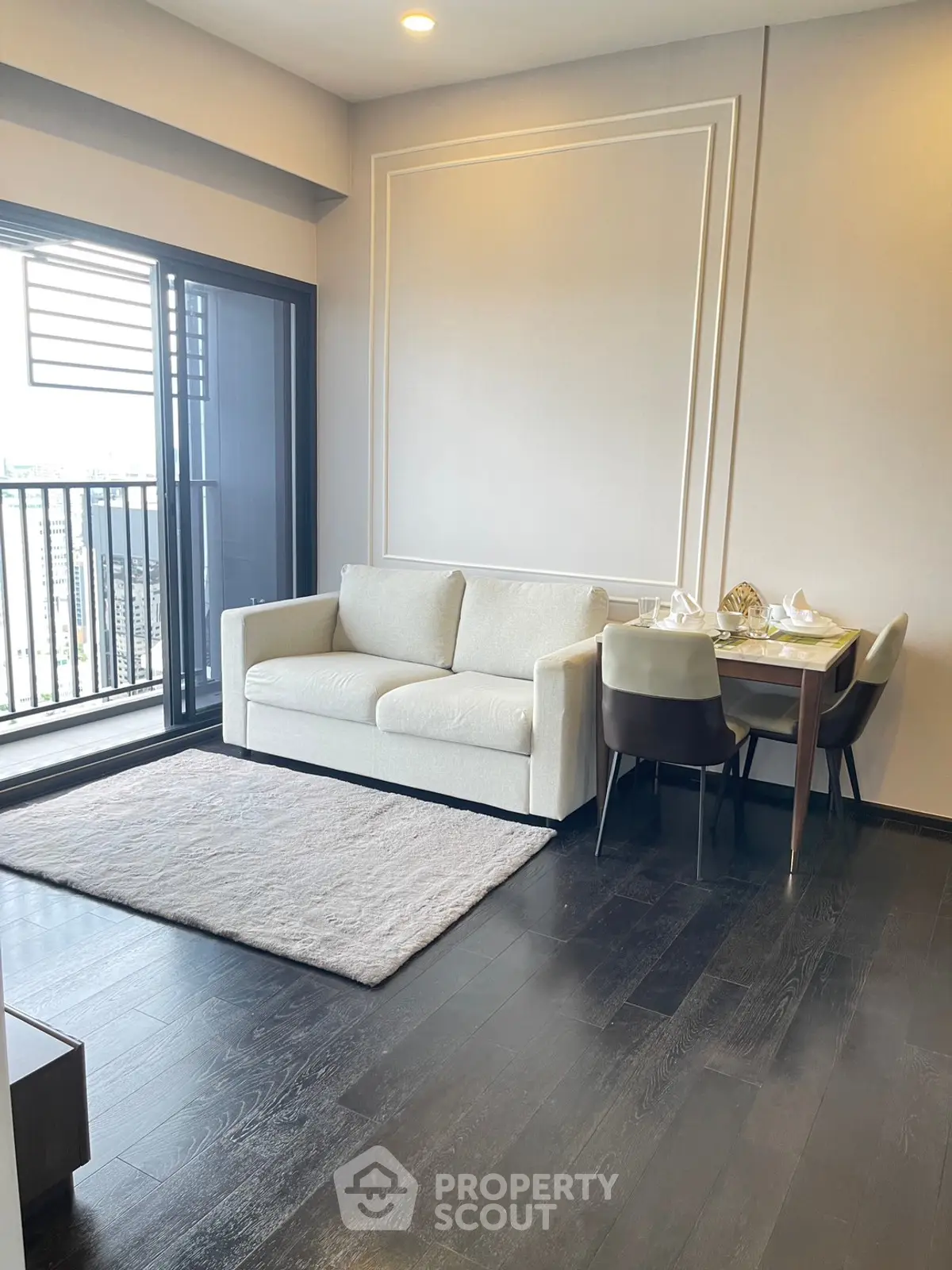 Modern living room with balcony view and elegant dining area