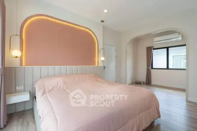 Modern bedroom with stylish lighting and large window