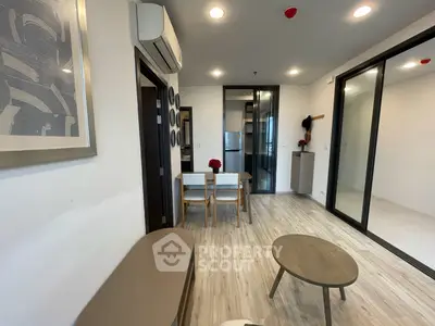 Modern living room with stylish decor and open layout, featuring sleek furniture and contemporary design.